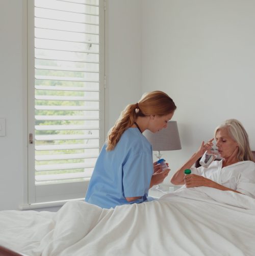 side-view-of-caucasian-female-doctor-giving-medici-2023-11-27-05-09-34-utc